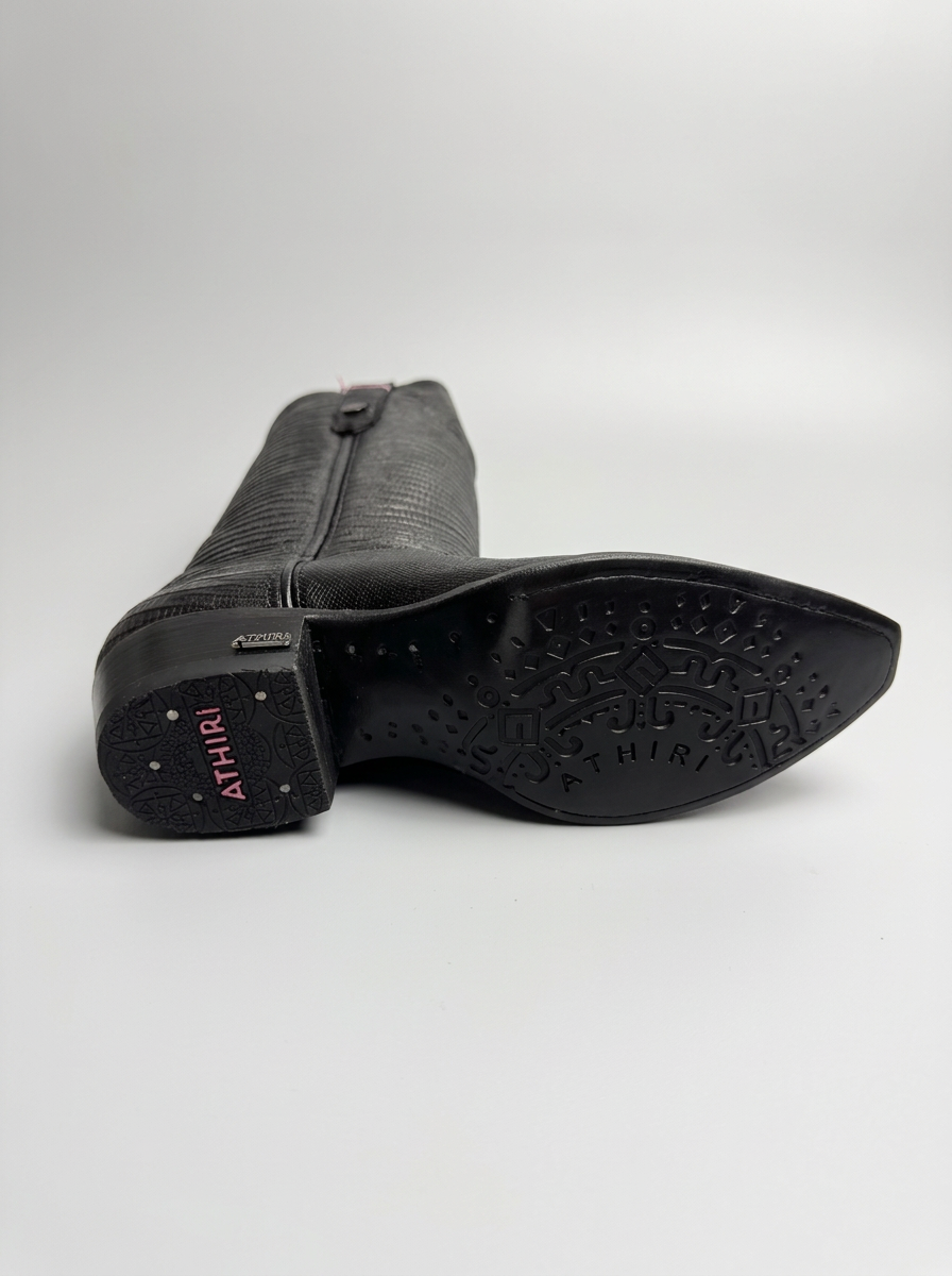 Lizard-embossed black leather western boot — sole detail